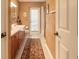 Inviting bathroom featuring double sinks, textured walls and neutral colored rugs at 6093 Sabal Creek Blvd, Port Orange, FL 32128