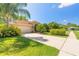 Charming one-story home boasting a well-manicured lawn, mature landscaping, and a two-car garage for added convenience at 6093 Sabal Creek Blvd, Port Orange, FL 32128