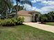Charming single-story home with lush landscaping, a two-car garage and well-maintained lawn at 6093 Sabal Creek Blvd, Port Orange, FL 32128