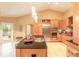 Bright kitchen featuring custom cabinets, stainless steel appliances, tile flooring, and a kitchen island with a sink at 6093 Sabal Creek Blvd, Port Orange, FL 32128
