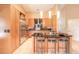 Well-lit kitchen featuring custom cabinets, stainless steel appliances, tile flooring, and a kitchen island with seating at 6093 Sabal Creek Blvd, Port Orange, FL 32128