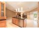 Kitchen island with black countertops, pendant lighting, and an open floor plan connecting to the living room and outdoor patio at 6093 Sabal Creek Blvd, Port Orange, FL 32128