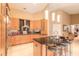 Spacious kitchen featuring custom cabinets, stainless steel appliances, tile flooring, and a kitchen island with seating at 6093 Sabal Creek Blvd, Port Orange, FL 32128