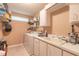 Functional laundry room with sink, storage cabinets, and modern washer and dryer at 6093 Sabal Creek Blvd, Port Orange, FL 32128