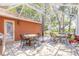 Outdoor patio area with brick pavers, multiple seating areas, and sun protection from trees and the screen at 6093 Sabal Creek Blvd, Port Orange, FL 32128