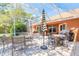 Relaxing screened patio with brick pavers, an umbrella, and dining furniture; ideal for outdoor entertaining at 6093 Sabal Creek Blvd, Port Orange, FL 32128