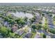 Beautiful aerial view of a community featuring a scenic lake and well-maintained homes at 634 Woodford Dr, Debary, FL 32713