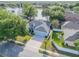 Aerial view of a well-kept home near a lake, featuring a screened pool, three-car garage, and a lush lawn at 634 Woodford Dr, Debary, FL 32713