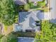 An overhead shot of a home with a screened-in pool, three car garage, and mature trees at 634 Woodford Dr, Debary, FL 32713