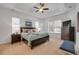 Cozy bedroom featuring a tray ceiling, soft natural light, and generous space at 634 Woodford Dr, Debary, FL 32713