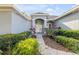 Charming home featuring a well-manicured lawn and covered entryway at 634 Woodford Dr, Debary, FL 32713