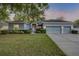 Charming single-story home featuring a three-car garage, manicured lawn, and a welcoming front entrance at 634 Woodford Dr, Debary, FL 32713