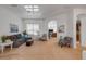 Open living room with neutral decor, comfortable seating and an archway to other rooms at 634 Woodford Dr, Debary, FL 32713