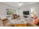 Bright living room with a ceiling fan, sliding glass doors, and comfortable seating at 634 Woodford Dr, Debary, FL 32713