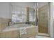 Bright bathroom features a soaking tub, and a glass enclosed shower for relaxation at 634 Woodford Dr, Debary, FL 32713
