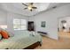 Comfortable main bedroom features a ceiling fan, window with blinds and an attached bathroom at 634 Woodford Dr, Debary, FL 32713