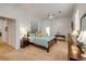 Bright main bedroom features a ceiling fan, neutral walls, plush carpet and ensuite bathroom at 634 Woodford Dr, Debary, FL 32713