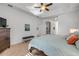 Comfortable main bedroom with ensuite bathroom, ceiling fan and plush carpeting at 634 Woodford Dr, Debary, FL 32713