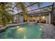 Covered lanai featuring a swimming pool, hot tub, and ample seating space at 634 Woodford Dr, Debary, FL 32713