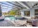 Screened in pool and hot tub with a spacious patio, adjacent to lush tropical landscaping at 634 Woodford Dr, Debary, FL 32713