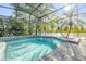 Screened-in pool with waterfall feature and attached spa at 634 Woodford Dr, Debary, FL 32713