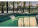 Screened-in pool with waterfall feature and lake views at 634 Woodford Dr, Debary, FL 32713