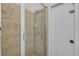 Tiled walk-in shower with glass door and a showerhead at 634 Woodford Dr, Debary, FL 32713