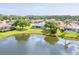 Scenic aerial view of a single-Gathering home overlooking a serene lake and lush greenery at 6403 Adrianne Ct, Port Orange, FL 32128