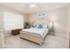 Comfortable bedroom with light-colored wood floors and beach-themed decor at 6403 Adrianne Ct, Port Orange, FL 32128
