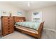 Bedroom featuring a wooden bed frame, wood dresser, and a bright window at 6403 Adrianne Ct, Port Orange, FL 32128