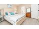 Serene bedroom featuring a queen bed and beach-themed decor, with ensuite bathroom access at 6403 Adrianne Ct, Port Orange, FL 32128