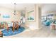 Open-concept dining area connecting to the kitchen and living room, featuring a round table and bright lighting at 6403 Adrianne Ct, Port Orange, FL 32128