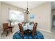 Elegant dining room with a round table, wicker chairs, stylish chandelier, and a large window at 6403 Adrianne Ct, Port Orange, FL 32128