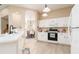 Open kitchen with white cabinets, stainless steel appliances, and an archway leading to the dining room at 6403 Adrianne Ct, Port Orange, FL 32128