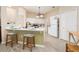 Bright kitchen featuring white cabinetry, modern appliances, a breakfast bar, and tile floors at 6403 Adrianne Ct, Port Orange, FL 32128