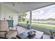 Cozy screened lanai offers a peaceful retreat with waterfront views and comfortable seating at 6403 Adrianne Ct, Port Orange, FL 32128