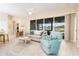 Bright living room with a comfortable seating area, large sliding glass doors, and a view of the lake at 6403 Adrianne Ct, Port Orange, FL 32128