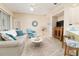 Spacious living room with a view of the kitchen, comfortable seating, and a seamless transition to the outdoors at 6403 Adrianne Ct, Port Orange, FL 32128
