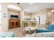 Inviting living room with neutral tones, a modern entertainment center, and an open view into the kitchen at 6403 Adrianne Ct, Port Orange, FL 32128