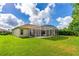 Home exterior showcases a screened lanai and large yard perfect for families and entertaining at 6436 Longlake Dr, Port Orange, FL 32128