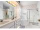 Bright bathroom features a dual sink vanity, soaking tub, and glass-enclosed shower at 6436 Longlake Dr, Port Orange, FL 32128