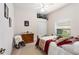 Cozy bedroom featuring a ceiling fan and a window overlooking the outdoors at 6436 Longlake Dr, Port Orange, FL 32128