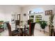 Elegant dining room featuring a glass table, four chairs, decorative plants, and a bright sunny window at 6436 Longlake Dr, Port Orange, FL 32128