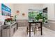 Eat-in dining room with a square wood table, 2 chairs, and a view of the screened lanai at 6436 Longlake Dr, Port Orange, FL 32128