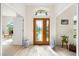 Bright foyer with a decorative glass front door, ceramic tile flooring, and elegant decorative accents at 6436 Longlake Dr, Port Orange, FL 32128
