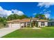 Charming single-story home with manicured lawn, tasteful landscaping, and welcoming curb appeal at 6436 Longlake Dr, Port Orange, FL 32128