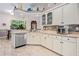 Bright eat-in kitchen features white cabinets, mosaic tile backsplash, and stainless steel appliances at 6436 Longlake Dr, Port Orange, FL 32128