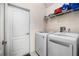 Convenient laundry room featuring a washer and dryer, plus shelving for storage at 6436 Longlake Dr, Port Orange, FL 32128