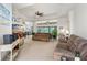 Spacious living room featuring tray ceilings, neutral carpet, comfortable seating, and plenty of natural light at 6436 Longlake Dr, Port Orange, FL 32128