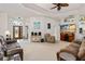 Bright living room with tray ceilings, modern entertainment center, and a view of the home's entry at 6436 Longlake Dr, Port Orange, FL 32128
